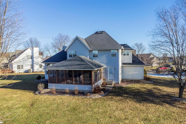 back of property with a lawn and a sunroom