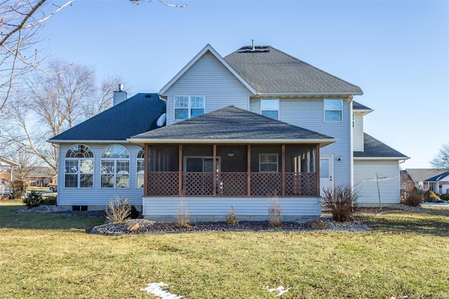 back of property with a sunroom and a yard