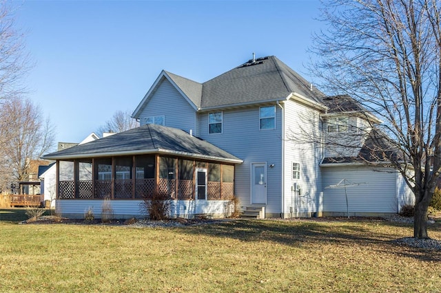 back of house featuring a yard and a sunroom