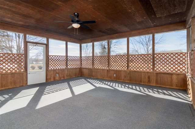 unfurnished sunroom featuring wooden ceiling and ceiling fan