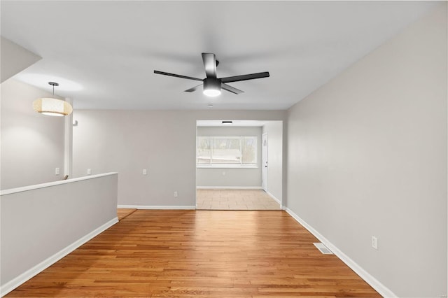 empty room featuring ceiling fan and light wood-type flooring