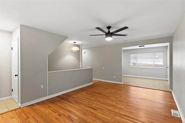 interior space with ceiling fan and light hardwood / wood-style floors