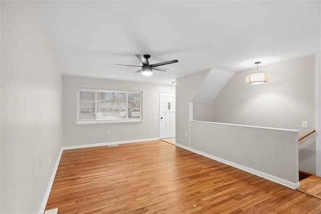 bonus room with ceiling fan and light hardwood / wood-style floors