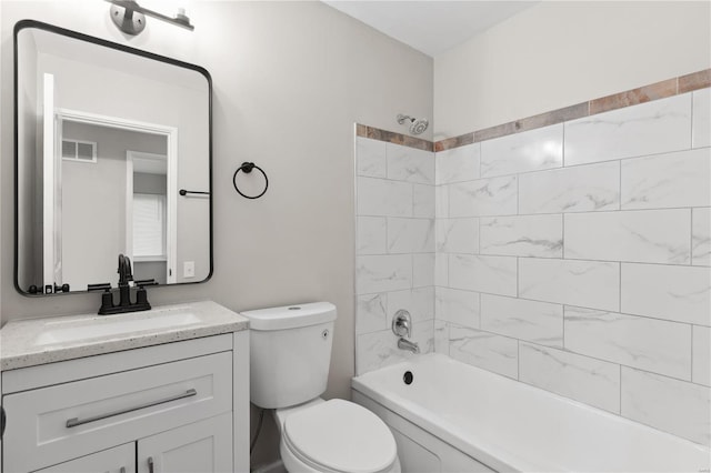 full bathroom with vanity, toilet, and tiled shower / bath combo