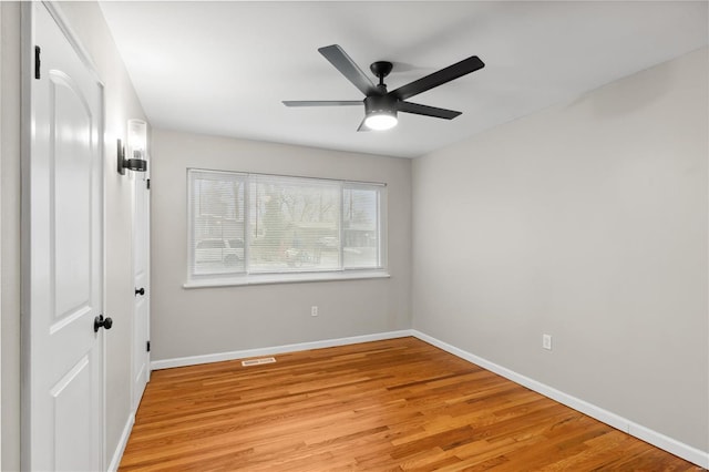 spare room featuring ceiling fan and light hardwood / wood-style flooring