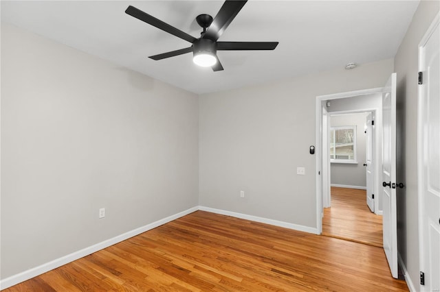 empty room with hardwood / wood-style floors and ceiling fan