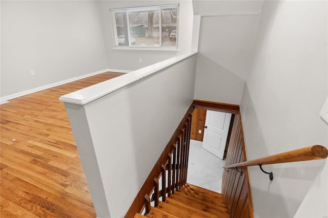 stairs featuring hardwood / wood-style floors