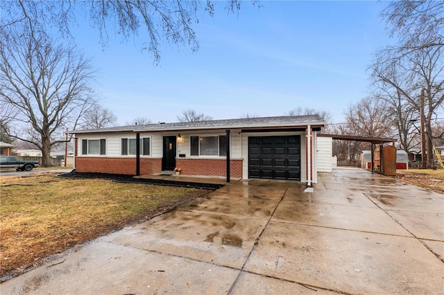 ranch-style home featuring a garage, a front lawn, and a carport