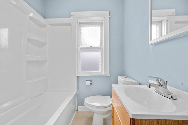 full bathroom featuring washtub / shower combination, vanity, and toilet