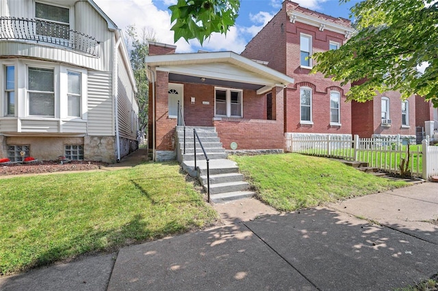 view of front of home featuring covered porch and a front lawn