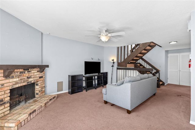 carpeted living room featuring stairs, a fireplace, a ceiling fan, and baseboards