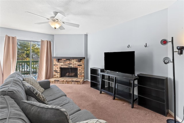 carpeted living room with a brick fireplace, ceiling fan, a textured ceiling, and baseboards