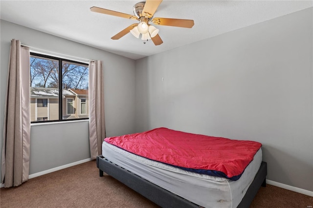 bedroom featuring a textured ceiling, carpet, a ceiling fan, and baseboards