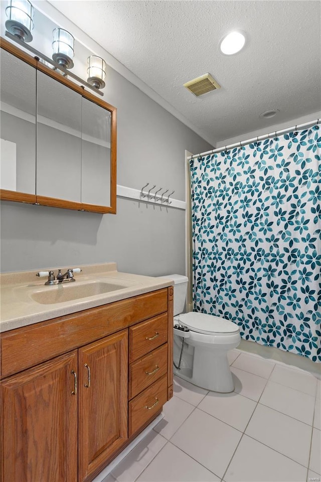 bathroom featuring toilet, a textured ceiling, vanity, and tile patterned floors