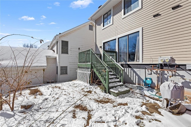 snow covered house with stairway