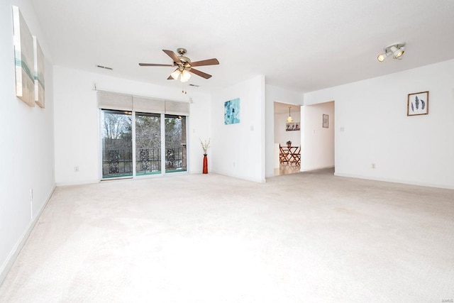 unfurnished room with ceiling fan and carpet