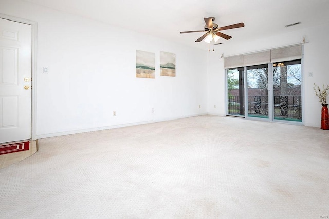 empty room with ceiling fan and carpet