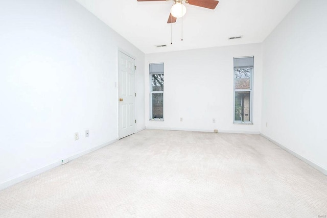 unfurnished room with ceiling fan and light carpet