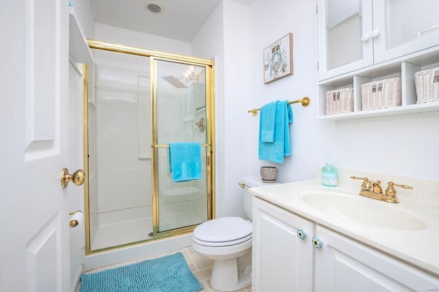 bathroom featuring vanity, tile patterned floors, toilet, and walk in shower