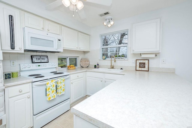 kitchen featuring white cabinetry, white appliances, sink, and decorative backsplash