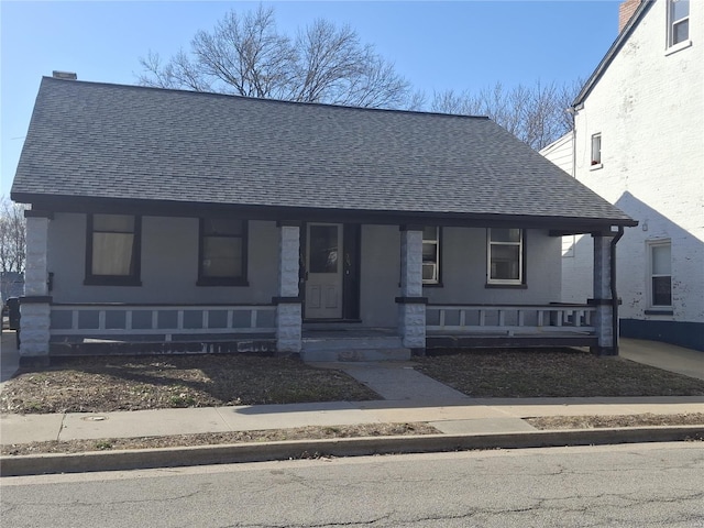 bungalow-style house featuring a shingled roof and a porch