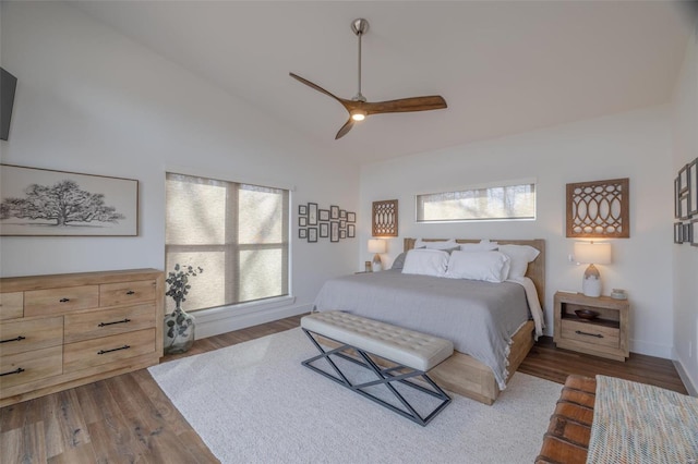 bedroom with lofted ceiling, dark hardwood / wood-style flooring, and multiple windows