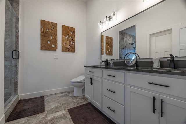 bathroom with vanity, a shower with shower door, and toilet