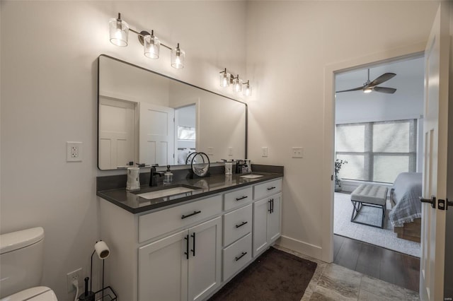 bathroom with ceiling fan, vanity, and toilet