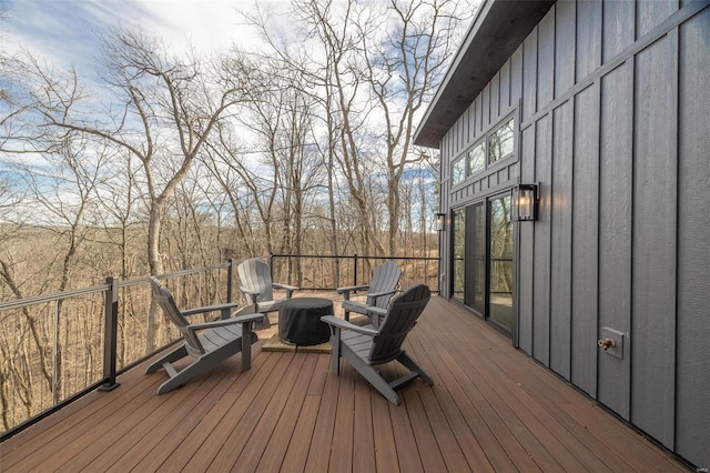 wooden terrace featuring an outdoor fire pit