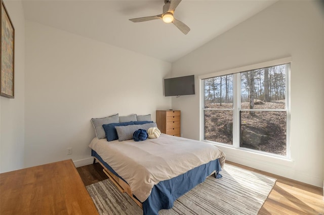 bedroom featuring ceiling fan, vaulted ceiling, and wood-type flooring