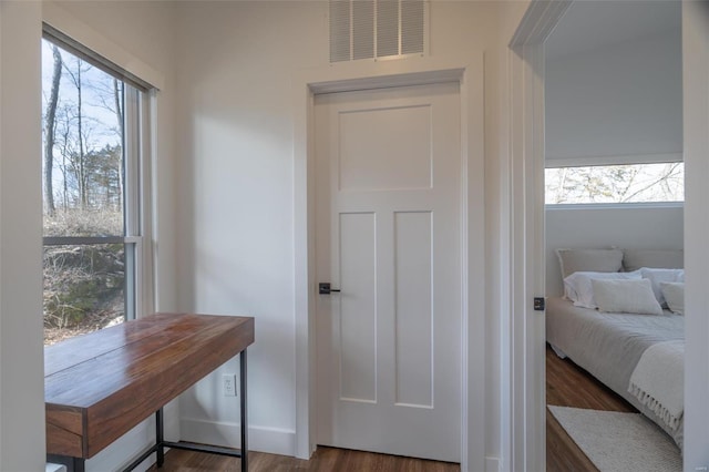 interior space with multiple windows and dark wood-type flooring