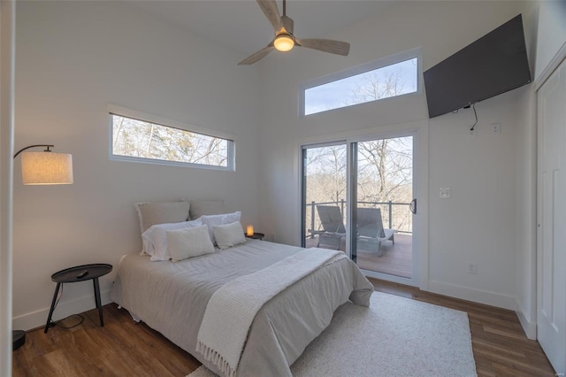 bedroom with dark hardwood / wood-style flooring, access to outside, and ceiling fan