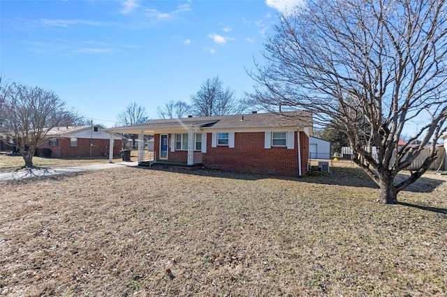 ranch-style home with central AC unit and covered porch