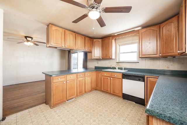 kitchen featuring white dishwasher, sink, kitchen peninsula, and ceiling fan