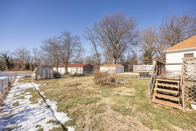 view of yard with a shed and a deck