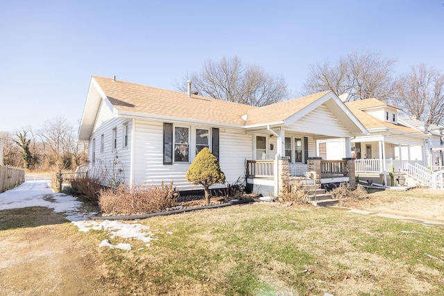 view of front of home with a front yard and covered porch