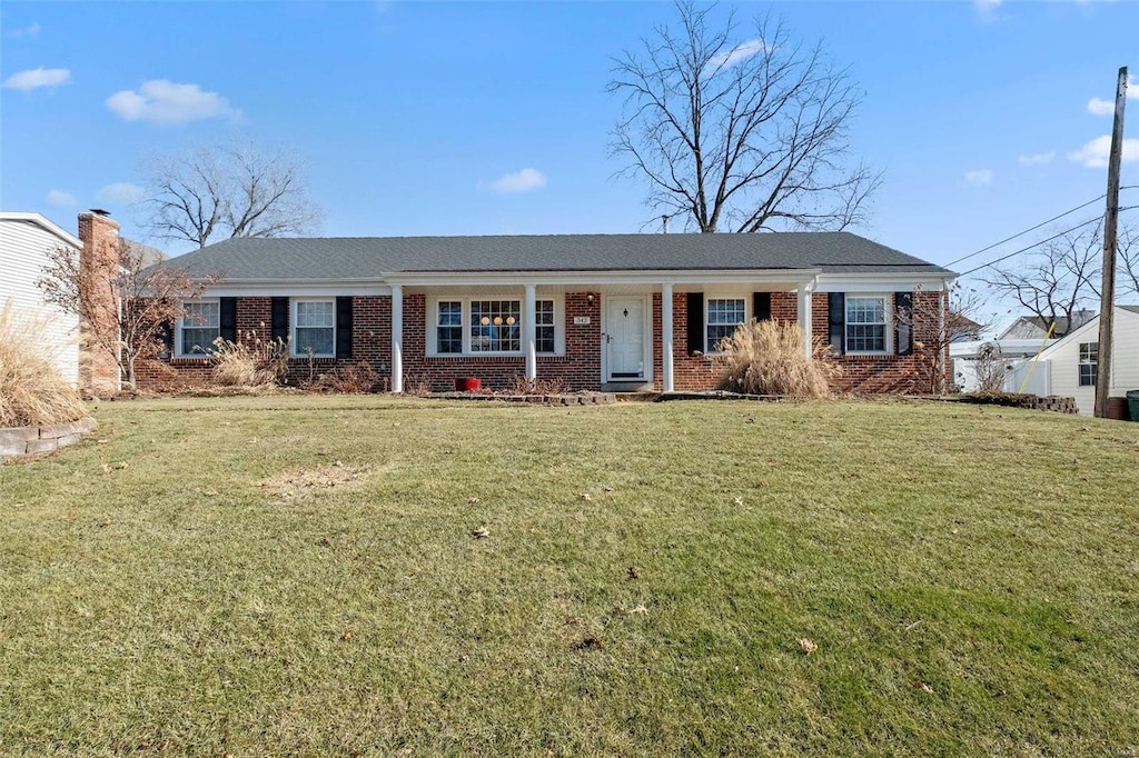 ranch-style home featuring a front yard