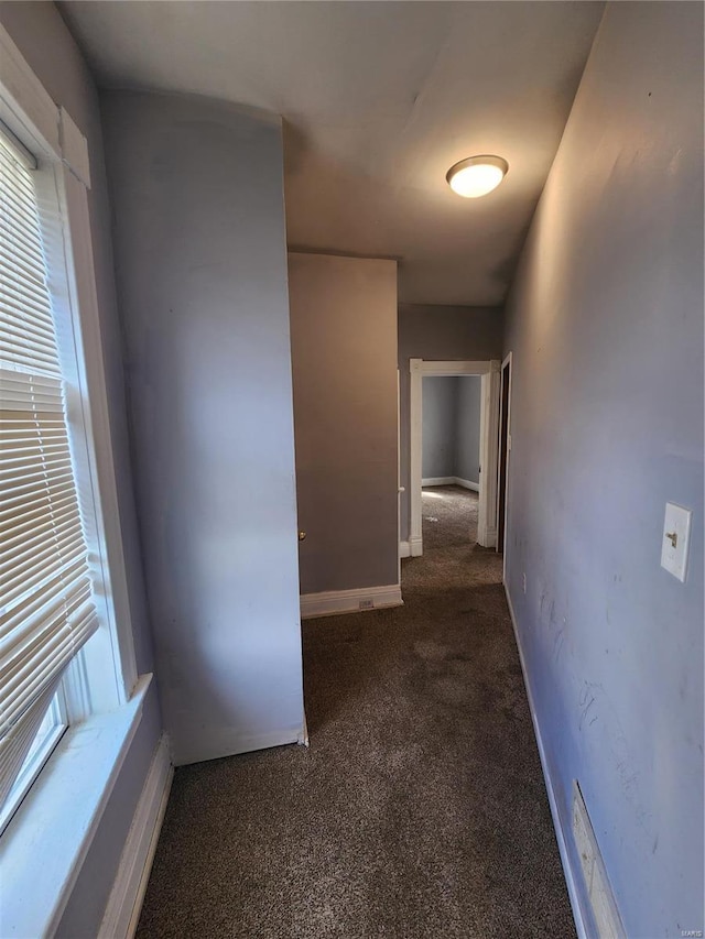 corridor with dark colored carpet