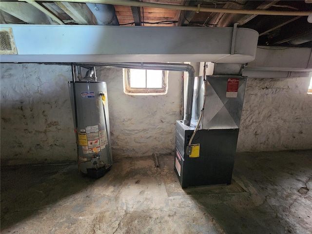 utility room with heating unit and water heater