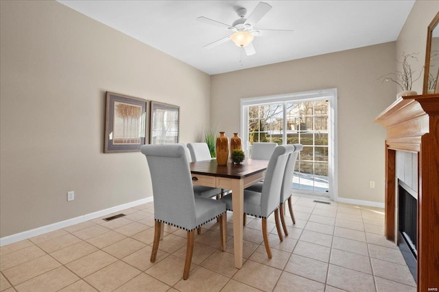 tiled dining area with ceiling fan