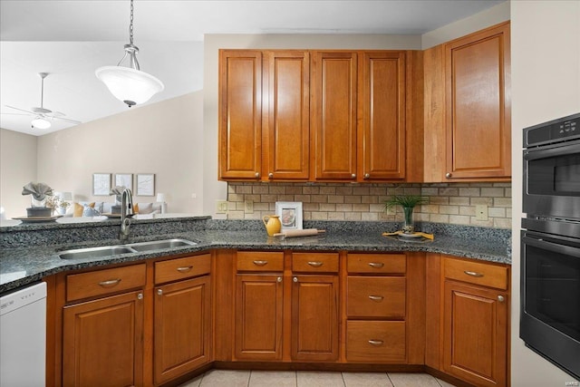 kitchen featuring double oven, white dishwasher, sink, and decorative backsplash