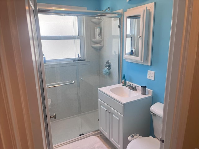 bathroom with vanity, toilet, and walk in shower