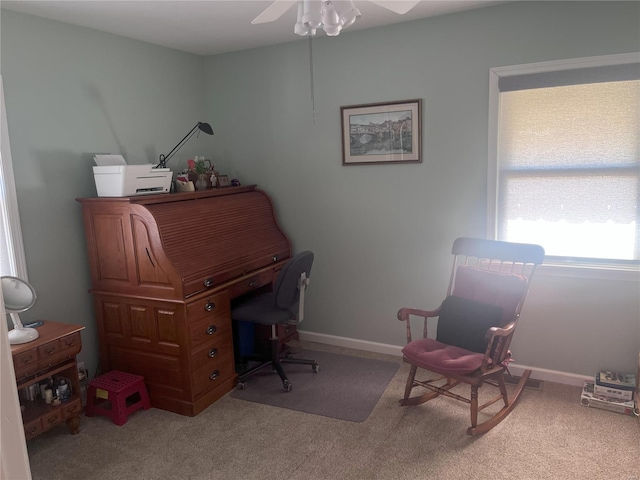 carpeted office space with ceiling fan