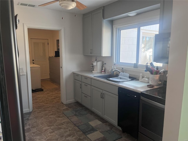 kitchen with sink, stainless steel range with electric stovetop, black dishwasher, ceiling fan, and white cabinets