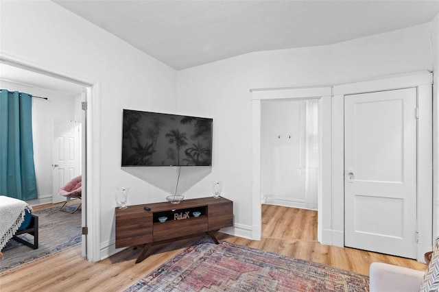 interior space featuring baseboards and wood finished floors