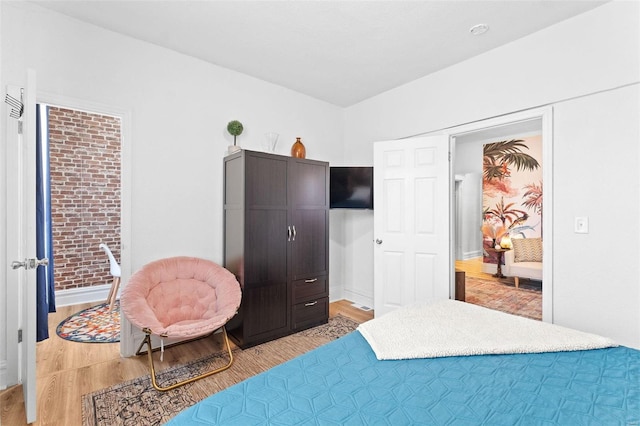 bedroom with baseboards and wood finished floors