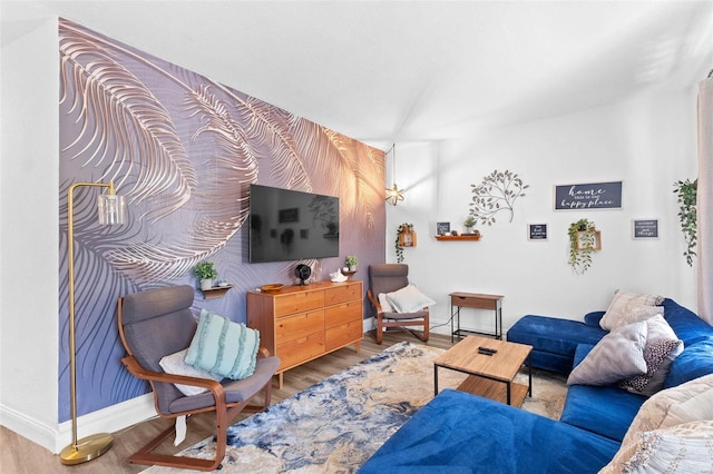 living room with baseboards and wood finished floors