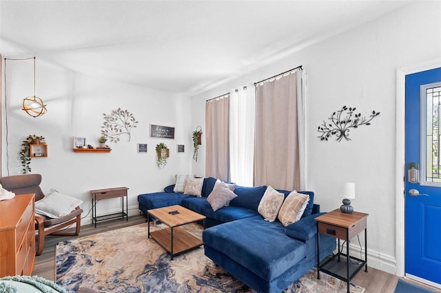 living area with wood finished floors and baseboards