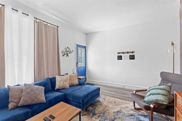 living area featuring baseboards and wood finished floors