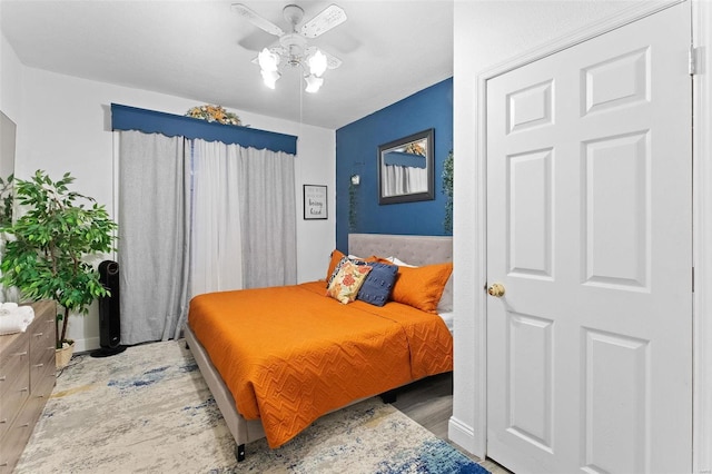 bedroom with a ceiling fan and wood finished floors